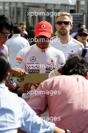 Lewis Hamilton (GBR) McLaren signs autographs for the fans. 07.10.2012. Formula 1 World Championship, Rd 15, Japanese Grand Prix, Suzuka, Japan, Race Day.