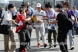 Michael Schumacher (GER) Mercedes AMG F1 signs autographs for the fans. 07.10.2012. Formula 1 World Championship, Rd 15, Japanese Grand Prix, Suzuka, Japan, Race Day.