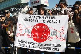 Banner for Sebastian Vettel (GER) Red Bull Racing at the pit lane walkabout. 04.10.2012. Formula 1 World Championship, Rd 15, Japanese Grand Prix, Suzuka, Japan, Preparation Day.