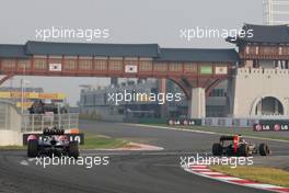 Kimi Raikkonen (FIN) Lotus F1 E20 pulls into the pits ahead of Mark Webber (AUS) Red Bull Racing RB8. 14.10.2012. Formula 1 World Championship, Rd 16, Korean Grand Prix, Yeongam, South Korea, Race Day.