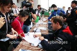 Sebastian Vettel (GER) Red Bull Racing signs autographs for the fans. 13.10.2012. Formula 1 World Championship, Rd 16, Korean Grand Prix, Yeongam, South Korea, Qualifying Day.
