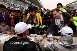 (L to R): Michael Schumacher (GER) Mercedes AMG F1 and Nico Rosberg (GER) Mercedes AMG F1 sign autographs for the fans. 13.10.2012. Formula 1 World Championship, Rd 16, Korean Grand Prix, Yeongam, South Korea, Qualifying Day.
