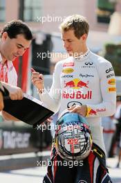 Sebastian Vettel (GER) Red Bull Racing signs autographs for the fans. 24.05.2012. Formula 1 World Championship, Rd 6, Monaco Grand Prix, Monte Carlo, Monaco, Practice Day