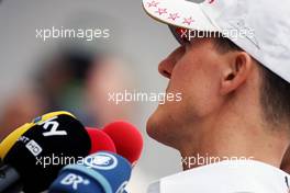 Michael Schumacher (GER) Mercedes AMG F1 with the media. 23.05.2012. Formula 1 World Championship, Rd 6, Monaco Grand Prix, Monte Carlo, Monaco, Preparation Day