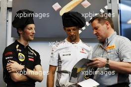 (L to R): Romain Grosjean (FRA) Lotus F1 Team; Jenson Button (GBR) McLaren; and Paul Hembery (GBR) Pirelli Motorsport Director at a Pirelli cooking competition, where the new Pirelli cook book was launched. 23.05.2012. Formula 1 World Championship, Rd 6, Monaco Grand Prix, Monte Carlo, Monaco, Preparation Day