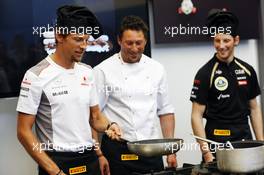 Jenson Button (GBR) McLaren and Romain Grosjean (FRA) Lotus F1 Team (Right) at a Pirelli cooking competition. 23.05.2012. Formula 1 World Championship, Rd 6, Monaco Grand Prix, Monte Carlo, Monaco, Preparation Day