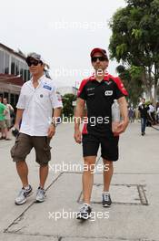 (L to R): Kamui Kobayashi (JPN) Sauber with Timo Glock (GER) Marussia F1 Team. 23.03.2012. Formula 1 World Championship, Rd 2, Malaysian Grand Prix, Sepang, Malaysia, Friday Practice