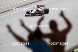 Lewis Hamilton (GBR) McLaren MP4/27 passes fans. 23.03.2012. Formula 1 World Championship, Rd 2, Malaysian Grand Prix, Sepang, Malaysia, Friday Practice