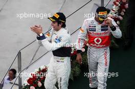 (L to R): Sergio Perez (MEX) Sauber celebrates his second position on the podium with Lewis Hamilton (GBR) McLaren. 25.03.2012. Formula 1 World Championship, Rd 2, Malaysian Grand Prix, Sepang, Malaysia, Sunday Podium