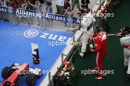 Race winner Fernando Alonso (ESP) Ferrari celebrates with the champagne with third placed Lewis Hamilton (GBR) McLaren and second placed Sergio Perez (MEX) Sauber on the podium. 25.03.2012. Formula 1 World Championship, Rd 2, Malaysian Grand Prix, Sepang, Malaysia, Sunday Podium