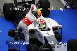 third placed Lewis Hamilton (GBR) McLaren congratulates second placed Sergio Perez (MEX) Sauber in parc ferme. 25.03.2012. Formula 1 World Championship, Rd 2, Malaysian Grand Prix, Sepang, Malaysia, Sunday Podium