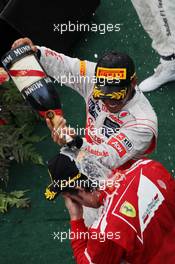Second placed celebrates with the champagne with race winner Fernando Alonso (ESP) Ferrari. 25.03.2012. Formula 1 World Championship, Rd 2, Malaysian Grand Prix, Sepang, Malaysia, Sunday Podium