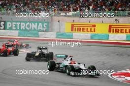 Michael Schumacher (GER) Mercedes AMG F1 W03 leads Vitaly Petrov (RUS) Caterham CT01. 25.03.2012. Formula 1 World Championship, Rd 2, Malaysian Grand Prix, Sepang, Malaysia, Sunday Race