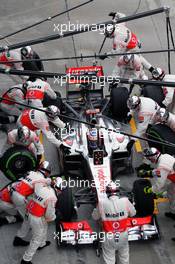 Jenson Button (GBR) McLaren MP4/27 makes a pit stop. 25.03.2012. Formula 1 World Championship, Rd 2, Malaysian Grand Prix, Sepang, Malaysia, Sunday Race