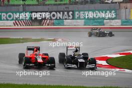 (L to R): Timo Glock (GER) Marussia F1 Team MR01 and Bruno Senna (BRA) Williams FW34 battle for position. 25.03.2012. Formula 1 World Championship, Rd 2, Malaysian Grand Prix, Sepang, Malaysia, Sunday Race
