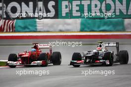 (L to R): Race winner Fernando Alonso (ESP) Ferrari F2012 and Sergio Perez (MEX) Sauber C31 battle for position. 25.03.2012. Formula 1 World Championship, Rd 2, Malaysian Grand Prix, Sepang, Malaysia, Sunday Race