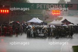The grid during the race delay as a thunderstorm occurs. 25.03.2012. Formula 1 World Championship, Rd 2, Malaysian Grand Prix, Sepang, Malaysia, Sunday Race