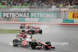 Lewis Hamilton (GBR) McLaren MP4/27 leads Jenson Button (GBR) McLaren MP4/27 and Mark Webber (AUS) Red Bull Racing RB8. 25.03.2012. Formula 1 World Championship, Rd 2, Malaysian Grand Prix, Sepang, Malaysia, Sunday Race