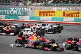 Sebastian Vettel (GER) Red Bull Racing RB8 and Fernando Alonso (ESP) Ferrari F2012 at the start of the race. 25.03.2012. Formula 1 World Championship, Rd 2, Malaysian Grand Prix, Sepang, Malaysia, Sunday Race