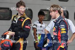 Romain Grosjean (FRA), Lotus Renault F1 Team and Sebastian Vettel (GER), Red Bull Racing  24.03.2012. Formula 1 World Championship, Rd 2, Malaysian Grand Prix, Sepang, Malaysia, Saturday Qualifying