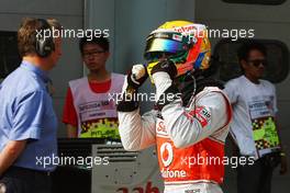 Lewis Hamilton (GBR) McLaren celebrates his pole position in parc ferme. 24.03.2012. Formula 1 World Championship, Rd 2, Malaysian Grand Prix, Sepang, Malaysia, Saturday Qualifying