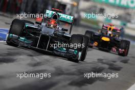 Michael Schumacher (GER), Mercedes AMG Petronas leads Sebastian Vettel (GER), Red Bull Racing out of the pits  24.03.2012. Formula 1 World Championship, Rd 2, Malaysian Grand Prix, Sepang, Malaysia, Saturday Qualifying
