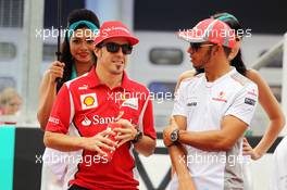 (L to R): Fernando Alonso (ESP) Ferrari and Lewis Hamilton (GBR) McLaren on the drivers parade. 25.03.2012. Formula 1 World Championship, Rd 2, Malaysian Grand Prix, Sepang, Malaysia, Sunday