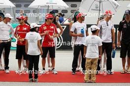 (L to R): Michael Schumacher (GER) Mercedes AMG F1; Felipe Massa (BRA) Ferrari; Fernando Alonso (ESP) Ferrari; Lewis Hamilton (GBR) McLaren and Jenson Button (GBR) McLaren on the drivers parade. 25.03.2012. Formula 1 World Championship, Rd 2, Malaysian Grand Prix, Sepang, Malaysia, Sunday
