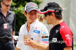 (L to R): Kamui Kobayashi (JPN) Sauber with Timo Glock (GER) Marussia F1 Team. 25.03.2012. Formula 1 World Championship, Rd 2, Malaysian Grand Prix, Sepang, Malaysia, Sunday