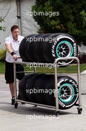 Mercedes AMG F1 mechanic wheels Pirelli tyres through the paddock. 22.03.2012. Formula 1 World Championship, Rd 2, Malaysian Grand Prix, Sepang, Malaysia, Thursday