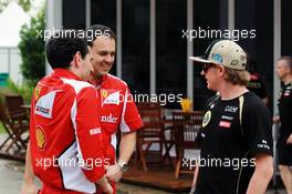 Kimi Raikkonen (FIN) Lotus E20 with members of the Ferrari team. 22.03.2012. Formula 1 World Championship, Rd 2, Malaysian Grand Prix, Sepang, Malaysia, Thursday