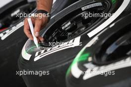 Pirelli tyres are marked up by a mechanic. 22.03.2012. Formula 1 World Championship, Rd 2, Malaysian Grand Prix, Sepang, Malaysia, Thursday