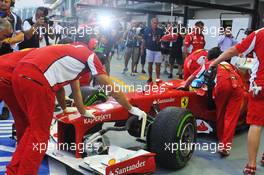 Photographers surround Fernando Alonso (ESP) Ferrari F2012 as he is pushed back in the pits. 21.09.2012.Formula 1 World Championship, Rd 14, Singapore Grand Prix, Singapore, Singapore, Practice Day