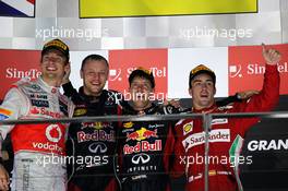 The podium (L to R): Jenson Button (GBR) McLaren, second; Ole Schack (DEN) Red Bull Racing mechanic; Sebastian Vettel (GER) Red Bull Racing, race winner; Fernando Alonso (ESP) Ferrari, third. 23.09.2012. Formula 1 World Championship, Rd 14, Singapore Grand Prix, Singapore, Singapore, Race Day