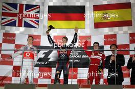 The podium (L to R): Jenson Button (GBR) McLaren, second; Sebastian Vettel (GER) Red Bull Racing, race winner; Fernando Alonso (ESP) Ferrari, third 23.09.2012. Formula 1 World Championship, Rd 14, Singapore Grand Prix, Singapore, Singapore, Race Day