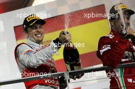 The podium (L to R): second placed Jenson Button (GBR) McLaren and third placed Fernando Alonso (ESP) Ferrari celebrate with the champagne. 23.09.2012. Formula 1 World Championship, Rd 14, Singapore Grand Prix, Singapore, Singapore, Race Day