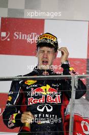 Race winner Sebastian Vettel (GER) Red Bull Racing celebrates on the podium. 23.09.2012. Formula 1 World Championship, Rd 14, Singapore Grand Prix, Singapore, Singapore, Race Day