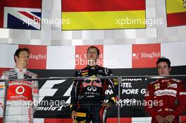 The podium (L to R): Jenson Button (GBR) McLaren, second; Sebastian Vettel (GER) Red Bull Racing, race winner; Fernando Alonso (ESP) Ferrari, third 23.09.2012. Formula 1 World Championship, Rd 14, Singapore Grand Prix, Singapore, Singapore, Race Day
