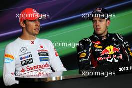 (L to R): second placed Jenson Button (GBR) McLaren and race winner Sebastian Vettel (GER) Red Bull Racing in the FIA Press Conference. 23.09.2012. Formula 1 World Championship, Rd 14, Singapore Grand Prix, Singapore, Singapore, Race Day