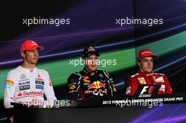 The post race FIA Press Conference (L to R): Jenson Button (GBR) McLaren, second; Sebastian Vettel (GER) Red Bull Racing, race winner; Fernando Alonso (ESP) Ferrari, third. 23.09.2012. Formula 1 World Championship, Rd 14, Singapore Grand Prix, Singapore, Singapore, Race Day