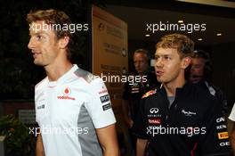 (L to R): Jenson Button (GBR) McLaren and Sebastian Vettel (GER) Red Bull Racing leave the Stewards office after the race. 23.09.2012. Formula 1 World Championship, Rd 14, Singapore Grand Prix, Singapore, Singapore, Race Day