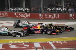 Romain Grosjean (FRA) Lotus F1 E20 leads Mark Webber (AUS) Red Bull Racing RB8; Michael Schumacher (GER) Mercedes AMG F1 W03 and Nico Rosberg (GER) Mercedes AMG F1 W03 at the start of the race. 23.09.2012. Formula 1 World Championship, Rd 14, Singapore Grand Prix, Singapore, Singapore, Race Day