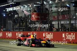 Race winner Sebastian Vettel (GER) Red Bull Racing RB8 celebrates as he takes the chequered flag at the end of the race. 23.09.2012. Formula 1 World Championship, Rd 14, Singapore Grand Prix, Singapore, Singapore, Race Day