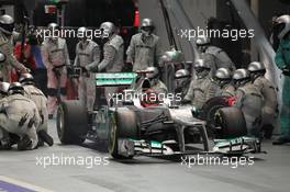 Michael Schumacher (GER) Mercedes AMG F1 W03 makes a pit stop. 23.09.2012. Formula 1 World Championship, Rd 14, Singapore Grand Prix, Singapore, Singapore, Race Day