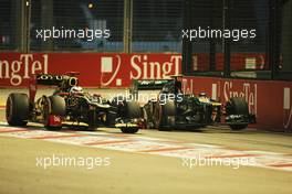 Kimi Raikkonen (FIN) Lotus F1 E20 passes the crashed Caterham CT01 of Vitaly Petrov (RUS) Caterham in the third practice session. 22.09.2012. Formula 1 World Championship, Rd 14, Singapore Grand Prix, Singapore, Singapore, Qualifying Day
