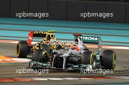 Michael Schumacher (GER) Mercedes AMG F1 W03 leads Romain Grosjean (FRA) Lotus F1 E20. 02.11.2012. Formula 1 World Championship, Rd 18, Abu Dhabi Grand Prix, Yas Marina Circuit, Abu Dhabi, Practice Day.