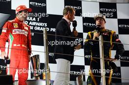(L to R): Fernando Alonso (ESP) Ferrari with David Coulthard (GBR) Red Bull Racing and Scuderia Toro Advisor / BBC Television Commentator and race winner Kimi Raikkonen (FIN) Lotus F1 Team on the podium. 04.11.2012. Formula 1 World Championship, Rd 18, Abu Dhabi Grand Prix, Yas Marina Circuit, Abu Dhabi, Race Day.