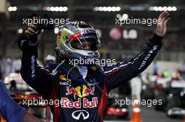 Sebastian Vettel (GER) Red Bull Racing celebrates his third position in parc ferme. 04.11.2012. Formula 1 World Championship, Rd 18, Abu Dhabi Grand Prix, Yas Marina Circuit, Abu Dhabi, Race Day.