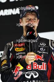 Sebastian Vettel (GER) Red Bull Racing on the podium. 04.11.2012. Formula 1 World Championship, Rd 18, Abu Dhabi Grand Prix, Yas Marina Circuit, Abu Dhabi, Race Day.