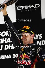 Sebastian Vettel (GER) Red Bull Racing celebrates his third position on the podium. 04.11.2012. Formula 1 World Championship, Rd 18, Abu Dhabi Grand Prix, Yas Marina Circuit, Abu Dhabi, Race Day.